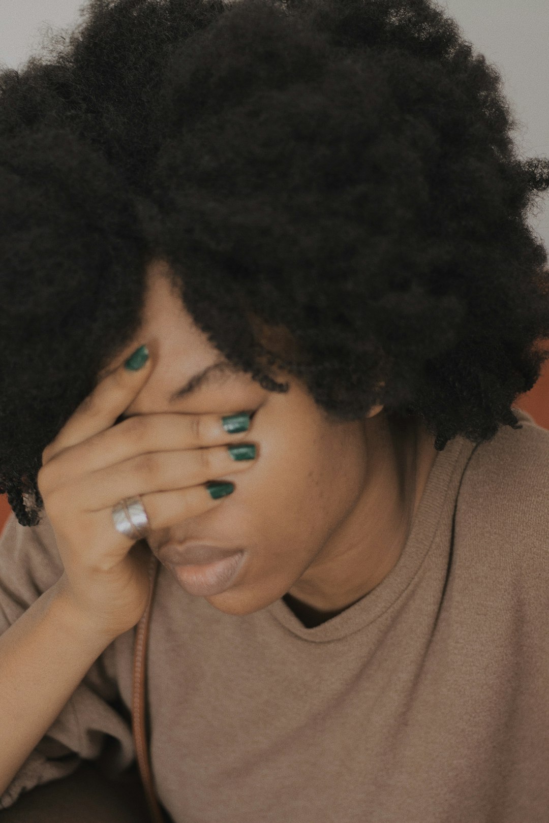 Photo by Baptista Ime James woman in brown crew neck shirt